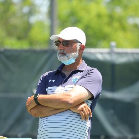 Burzis Kanga on the feild as the coach.